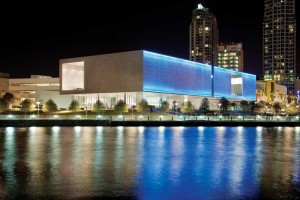 The Tampa Museum of Art’s distinctive two-layer perforated aluminum façade uses a pattern of 76-mm (3-in.) diameter holes spaced in straight rows 25 mm (1 in.) apart. Highlighting the metallic aesthetic and providing durable protection for the Florida climate, the aluminum was finished in a clear anodize. Colored lights are installed between the layers of perforated panels and illuminate on a timed rotation to bring the building to life at night. Photo © Richard Barnes. Photo courtesy Tampa Museum of Art