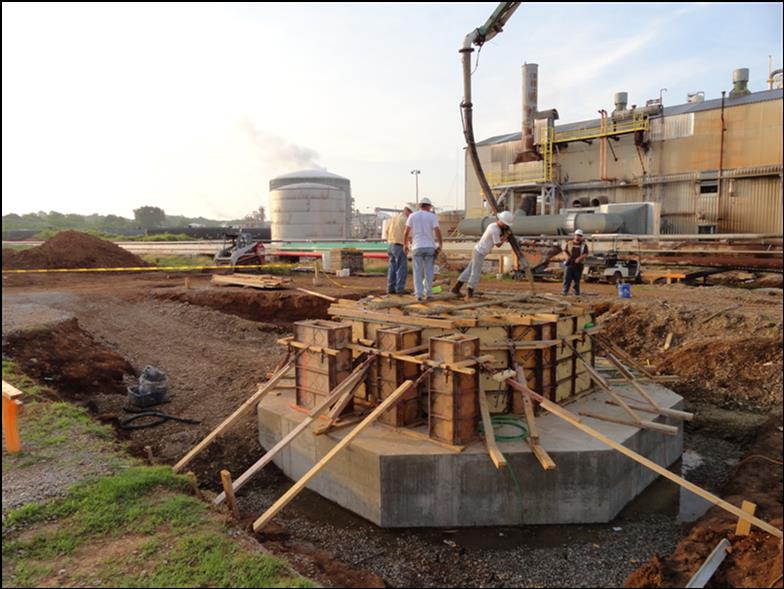Placement of a pedestal base for a nitric acid absorber using activated fly-ash cement concrete in Tuscumbia, Alabama, to alleviate corrosion damage.