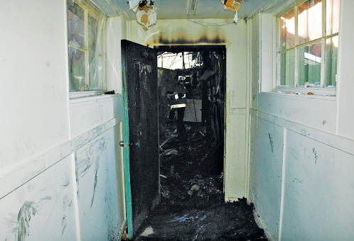 The purpose of a fire door is to compartmentalize a building and prevent the spread of smoke and flames. The door shown in these photos protected a nature center and management offices from a fire that began in the maintenance shop. Photos courtesy Fire Protection Specialist Christopher Taylor, NYS Offi ce of Fire Prevention and Control