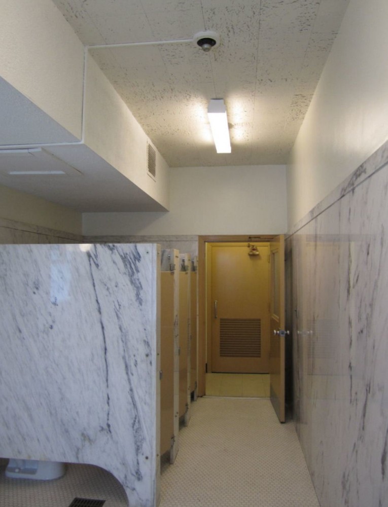 This door lacks proper maneuvering clearance on the egress side. If an automatic operator were to be installed to overcome this issue, the 2010 ADA requires standby power for the operator.