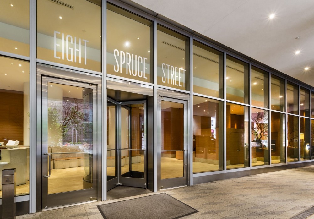 Stainless steel stile and rail-type balanced doors were used on New York by Gehry in New York City to provide a transparent aesthetic for the glass-enclosed lobby. [CREDIT] Photo © Barry Schwartz Photography 