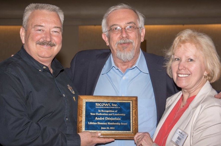 André Désjarlais, (RICOWI’s) recipient of Lifetime Honorary Membership, is flanked by the association’s chair, Michael Ennis, and executive director, Joan Cook. This year marks RICOWI’s silver anniversary.