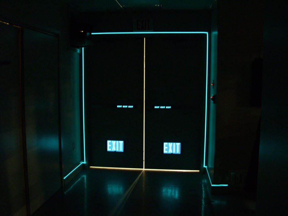 Electro-luminescence (EL) indicates an electric-powered, uninterrupted light source that increases visibility to locate exit doors. Photo courtesy Egress Marking Systems