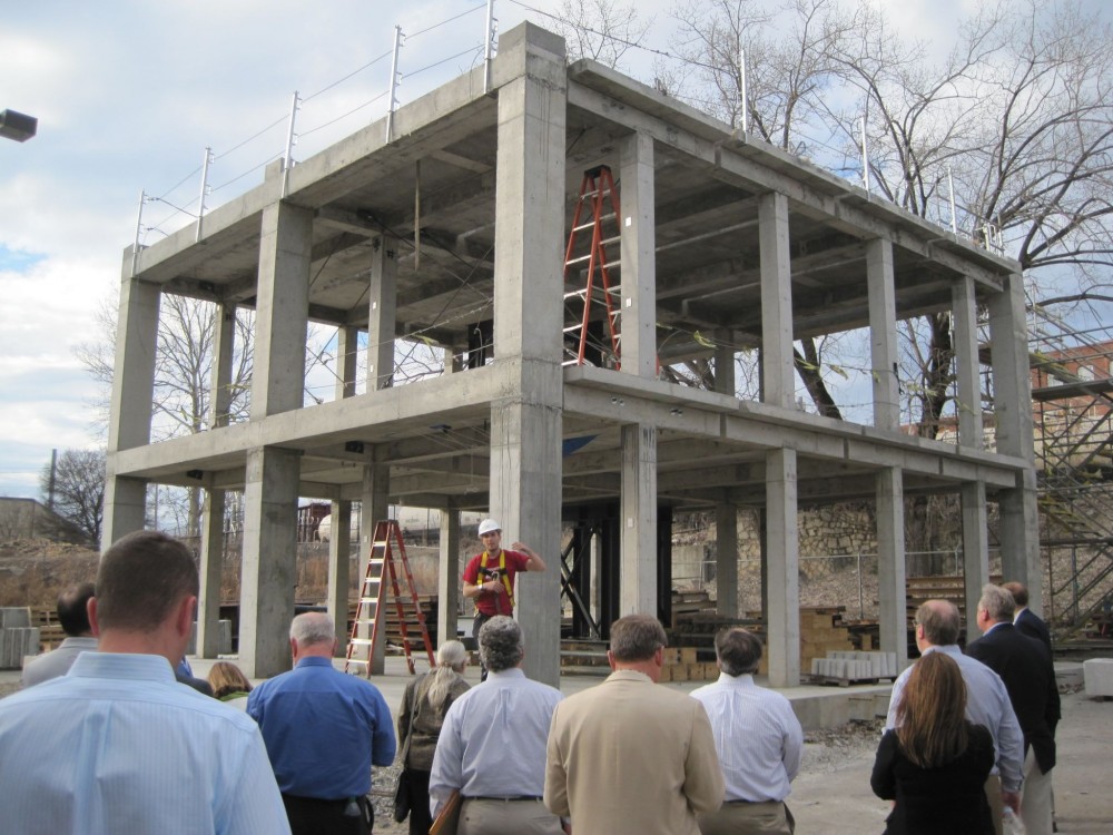 The newly formed Concrete Research Network (CRN) will connect researchers, donors, and funders. This student researcher is explaining an innovative seismic retrofit for a reinforced full-scale, two-story concrete building. Photo © Ann Daugherty. Photo courtesy ACI Foundation