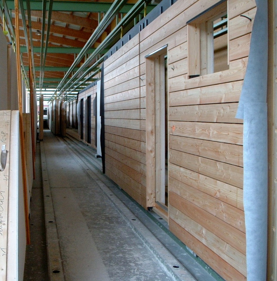 For new-generation wood projects, walls are simply stood up and windows, siding, and trim are installed. Photo courtesy Nabih Tahan