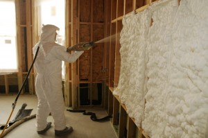 The installation of sprayfoam insulation in wood framed walls is shown here.