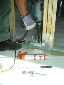 Pure epoxy is typically just an epoxy resin and a hardener, and its slow cure rate makes it prone to sagging if it is used for overhead applications. But pure epoxy is ideal for “downward installations” (shown) of an anchor bolt in dry concrete, yielding best-in-class strength. As in all cases, the holes has to be drilled and then cleaned out of concrete dust that may defeat the bonding power of the epoxy. Pure epoxy is typically just an epoxy resin and a hardener, and its slow cure rate makes it prone to sagging if it is used for overhead applications. But pure epoxy is ideal for “downward installations” (shown) of an anchor bolt in dry concrete, yielding best-in-class strength. As in all cases, the holes has to be drilled and then cleaned out of concrete dust that may defeat the bonding power of the epoxy.