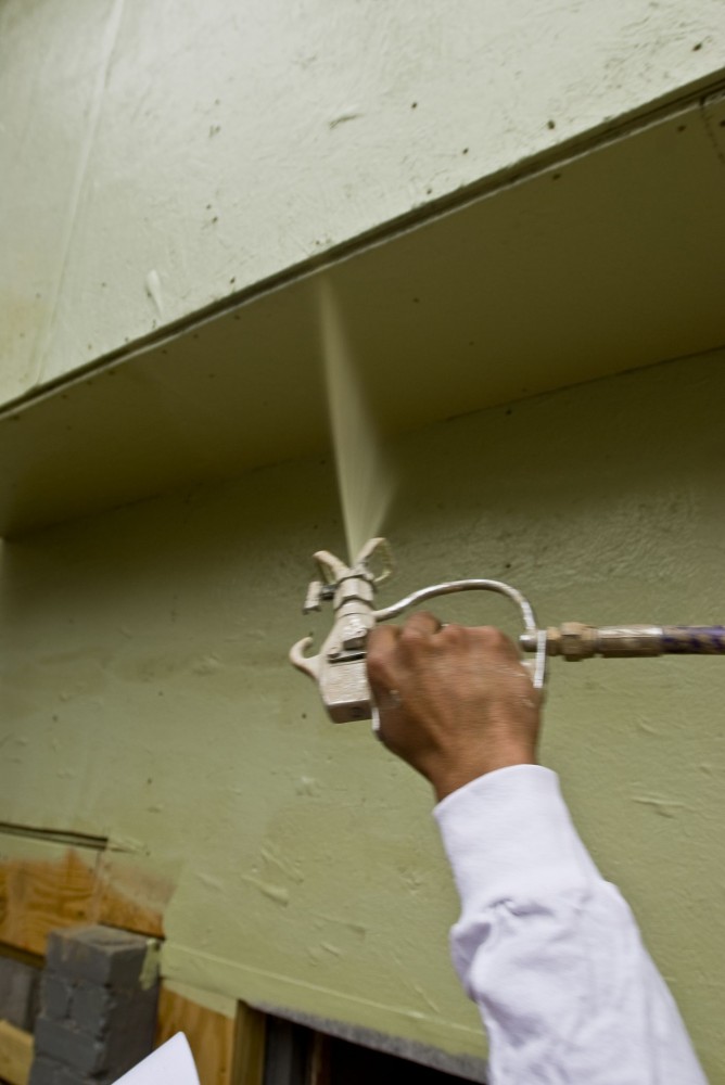 This shows the application/spraying of a fluid-applied air and moisture barrier, providing superior protection against air and moisture intrusion in various applications.