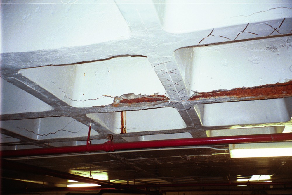 Unable to evaporate through the coated surface, water entering the slab migrates to the reinforcing steel, leading to corrosion and spalls.