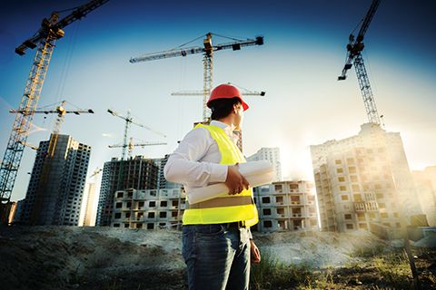 bigstock-Man-In-Hardhat-And-Green-Jacke-94590356