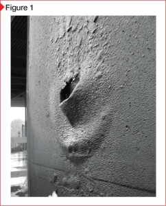 A large, water-filled blister in a cured membrane after a rain event. As with all photos in this article, the image is presented in black and white in order to prevent product identification.