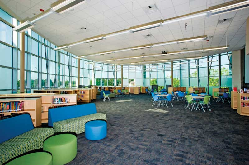 Daylighting elements, as shown here in the library, allow the facility to reduce heating and lighting costs, attributing to its net-zero rating. It was built to achieve Gold under Leadership in Energy and Environmental Design (LEED). Photos courtesy Fabral
