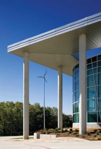 Energy-efficient applications such as wind turbines, solar roof panels, and a large metal-clad canopy were all incorporated into the design of Lady Bird Johnson Middle School, the first net-zero middle school in the United States.