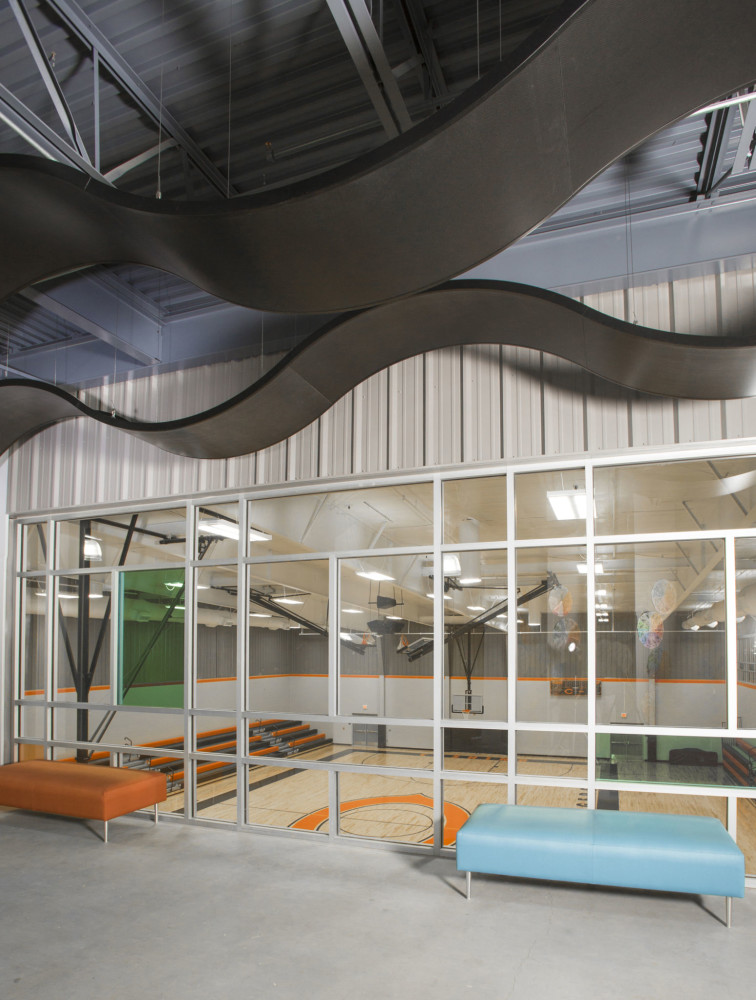 The new Cushing Middle School in Oklahoma features curved aluminum ceiling panels to create interest and to help promote quiet, comfortable learning spaces. Photos courtesy Rockfon. Photos by Miller Photography Inc.