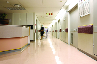 Looking down a hospital hall way lights