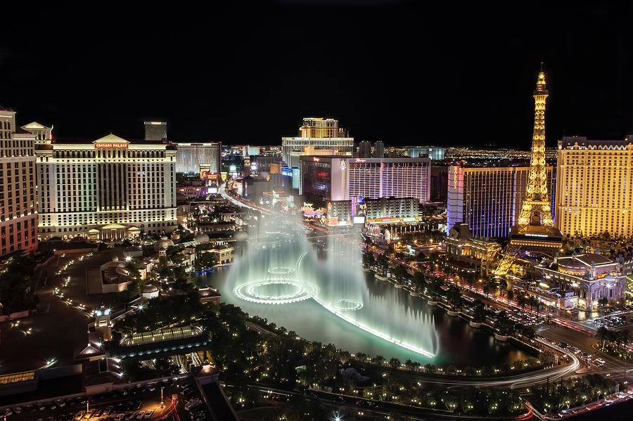 LAS VEGAS, USA - July 1, 2012: Fountain show at Bellagio hotel and casino in Las Vegas, USA. Caesars Palace, The Flamingo and Bally's casino are in the back ground.