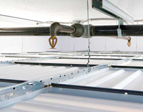 Why fire sprinklers belong above suspended drop-out ceilings