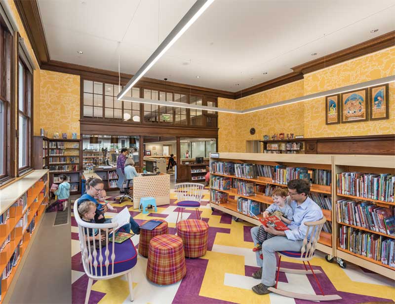 A gypsum board ceiling suspended on resilient clips with sound-absorbing batt insulation in the ceiling plenum was employed to achieve sound isolation at the Children’s Reading Room at The Jamaica Plain branch of the Boston Public Library, Massachusetts. Photo © Anton Grassl. Photo courtesy Utile