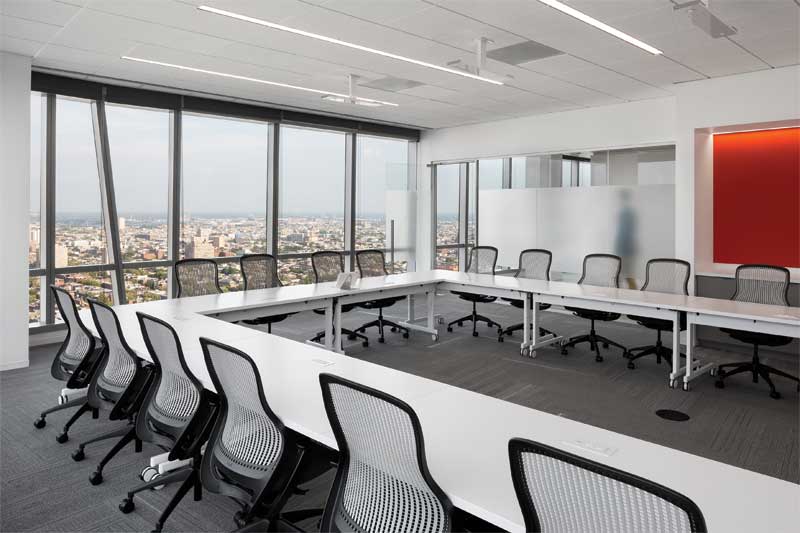 Mineral fiber panels with balanced sound absorption and sound-blocking capabilities control background sound within and prevent sound leakage from the FMC Corporation conference room.