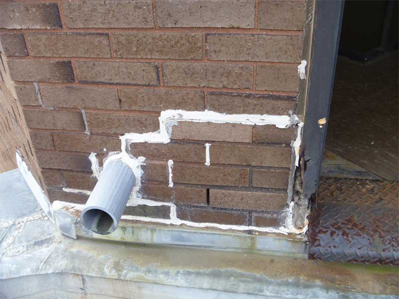 A sealant is being misused to repair mortar joints in this building.