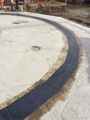 Figure 1: Small cracks in a concrete foundation wall can simply be detailed with a minimum 229-mm (9-in.) membrane strip, and covered with a waterproofing membrane.