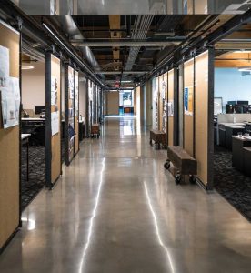 Sliding cork dividers and reclaimed timber trusses train line the hallways of Ankrom Moisan’s headquarters in Portland.