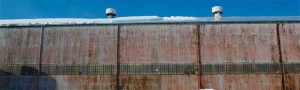 Failing industrial windows show signs of discolored glazing and rusted frames that significantly compromise performance, light transmission, and appearance. Photos courtesy EXTECH