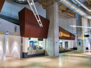 Natural
wood-grain architectural finishes were added to the concession stands in the stadium to help them stand out.