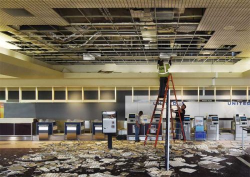 Figure 10: Vulnerability to moisture, whether from leaks, condensation,
or firefighting, should be considered when selecting ceiling systems. After a fire in 2018, portions of the airport in Colorado Springs, Colorado, had to be closed due to water damage that required clean-up and replacement of wet and falling ceiling panels. Photo © Jerilee Bennett/The Gazette via AP