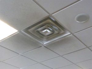 Figure 7: Particulates in air supply tend to cling to adjacent ceiling surfaces due to Coandã effect. Soot, at this international airport, is particularly hard to remove from crevices and pores in mineral fiber panels.