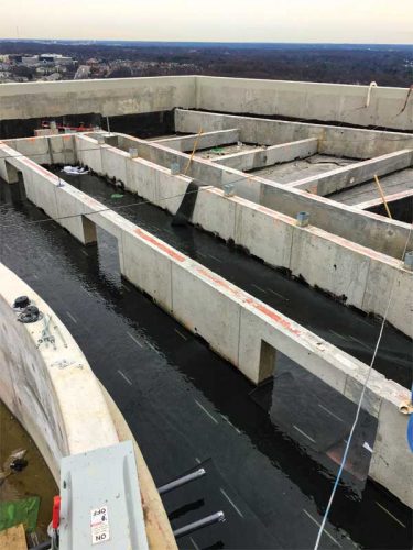 Figure 2: Ongoing construction of concrete stem walls to support a raised rooftop amenity deck.
