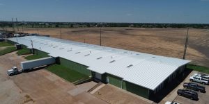 The versatility of a symmetrical standing seam metal roofing system helped Northwest Distributors deal with damaged metal roofing at their warehouse in Hays, Kanas. Photo courtesy Roofmasters