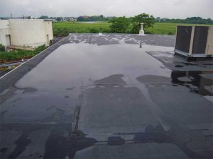Figure 1: Ponded water can be observed between the outer perimeter of the structure and the rooftop unit (RTU). This ponded water will remain until evaporation takes place. Images courtesy Alliance Roof Consultants, Inc.