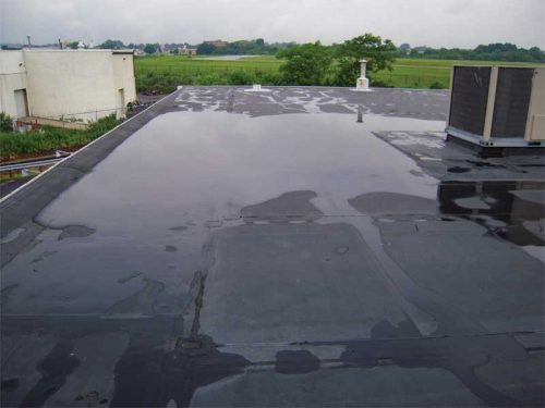 Figure 1: Ponded water can be observed between the outer perimeter of the structure and the rooftop unit (RTU). This ponded water will remain until evaporation takes place. Images courtesy Alliance Roof Consultants, Inc.