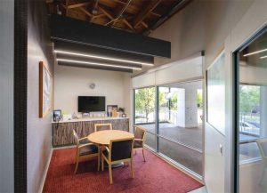 Integrated acoustic lighting systems are available in a variety of form factors, including linear baffles (shown here). Photo © by John Sternisha