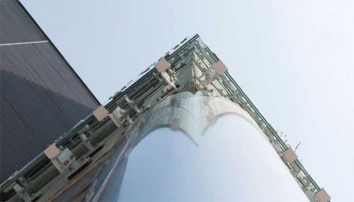 Detail of one of the corner conditions, where the glass cladding wraps around the cylindrical loadbearing columns. This presented a significant engineering challenge, requiring several customized steel plates and embeds to accomplish the clean detail.