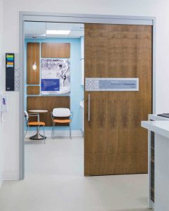 Barn-style commercial doors allow patients and staff to navigate easily between spaces without losing critical room.