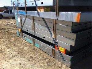 Bundles of pallets have color-coded labels not only for the panels’ final location within the building, but also for where the bundles need to be staged. Spacers are installed between panels to facilitate lifting by forklifts that are fitted with fork extensions. Photos courtesy Don Allen, Super Stud Building Products