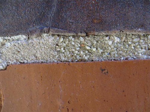 A close-up view shows the variation in size and color of sand aggregate in the existing pointing mortar.