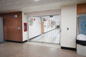 A rolling grille in a school to provide protection from modern security risks.