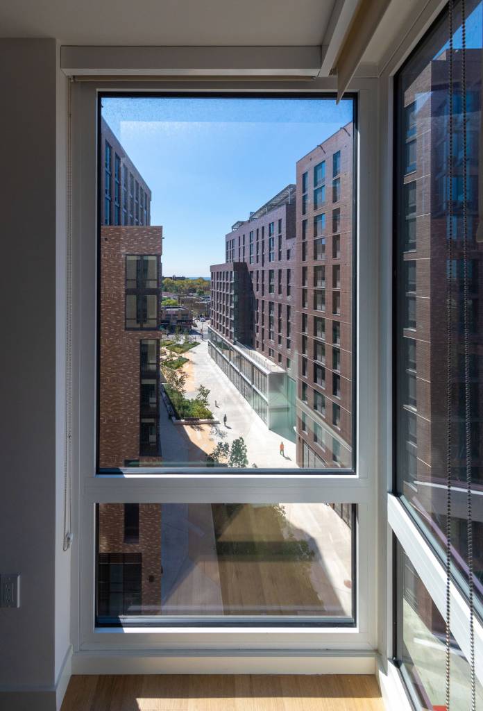 The street between the buildings is enhanced by an irregular wall.