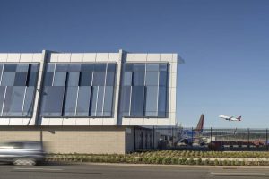 Closeup shows the pattern of colored glazing on the south facade, inspired by Oregon forests.