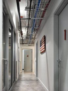 An interior hallway in neutral tones and simple materials.
