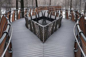 A photo showing an elevated pathway bounded by a cable railing.