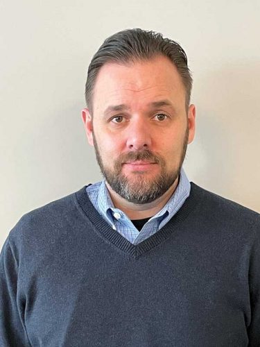 man with a shirt and a grey blue sweater