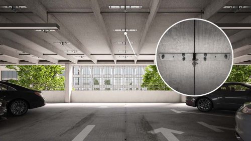 A modern multi-level parking garage with exposed concrete beam ceilings, featuring a detailed inset showing a close-up of a connection joint with metal fasteners and bolts for structural reinforcement.
