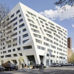 A building with a limestone, textured finish.