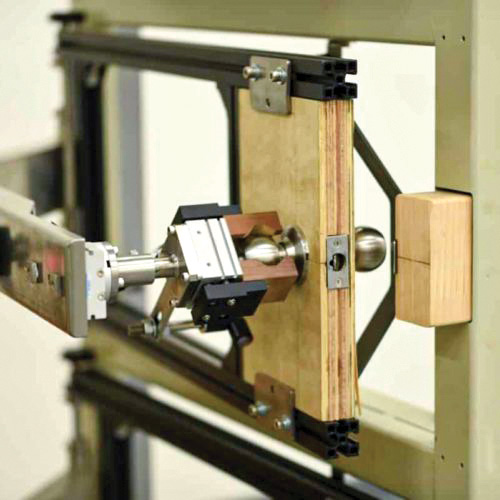 A mechanical testing apparatus featuring a mounted specimen holder and an adjustable clamp, used for material strength testing.