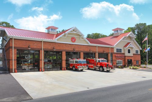 Ocean City Fire Department with red trucks parked outside and high-performance rolling grilles on each bay door.