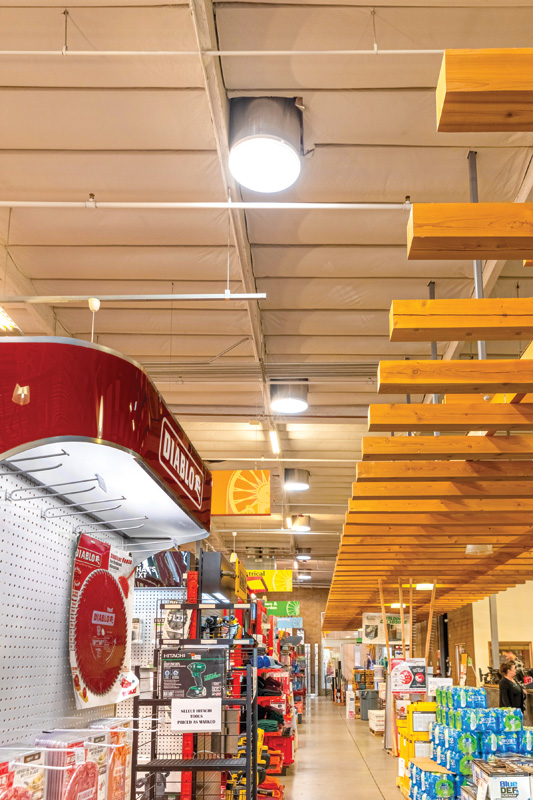 A well-lit hardware store aisle with products displayed, featuring overhead wooden beams and the "DIABLO" brand prominently.